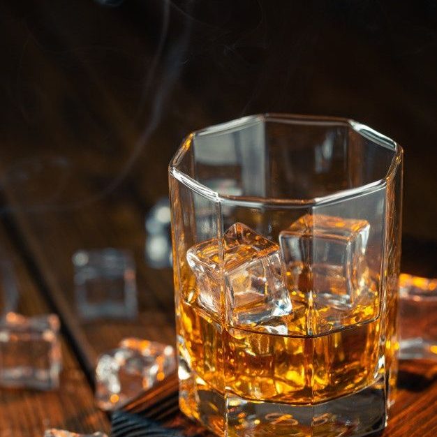 Premium Photo _ Whiskey in glass with ice